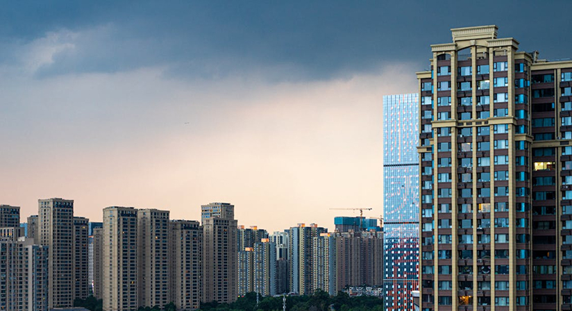 Dense urban skyline under cloudy skies with modern high-rise buildings, highlighting city architecture and growth.